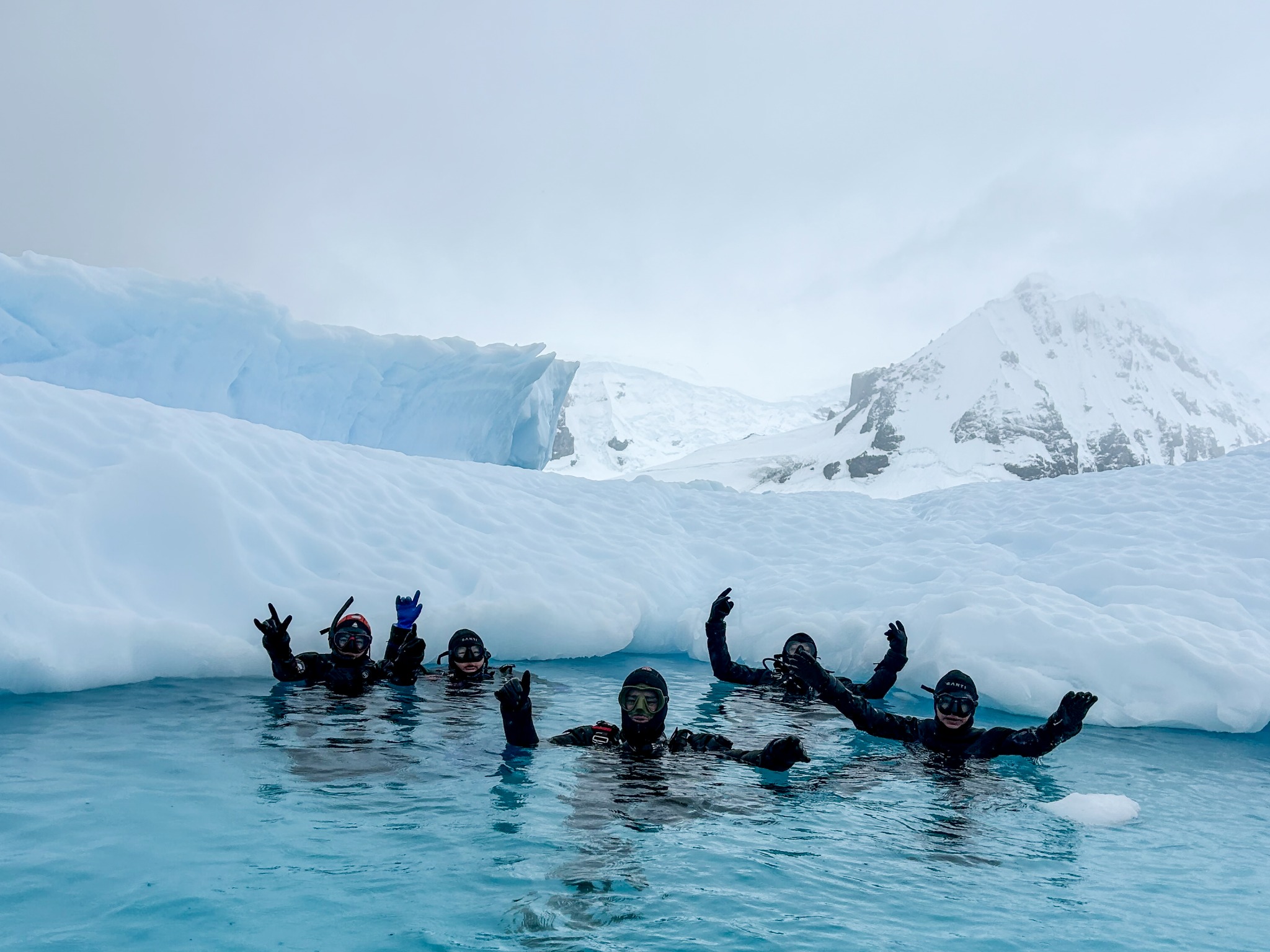 Polar divers surrounded by sea ice in Antarctica